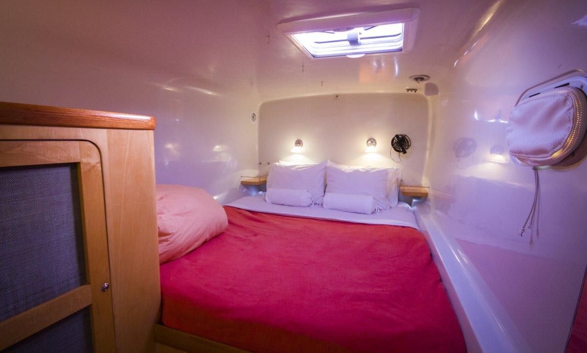 a room with a bed and a mirror aboard ZENYATTA Yacht for Charter