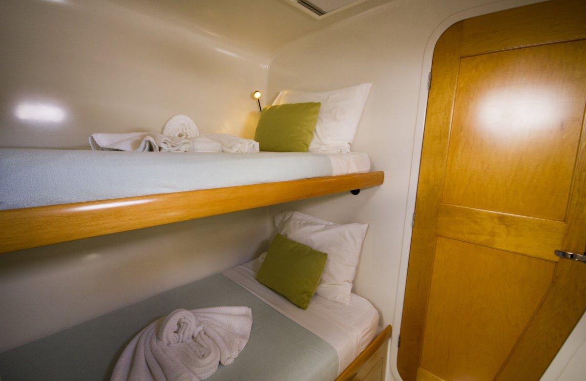 a bed with a white pillow and a white pillow on it aboard ZENYATTA Yacht for Charter