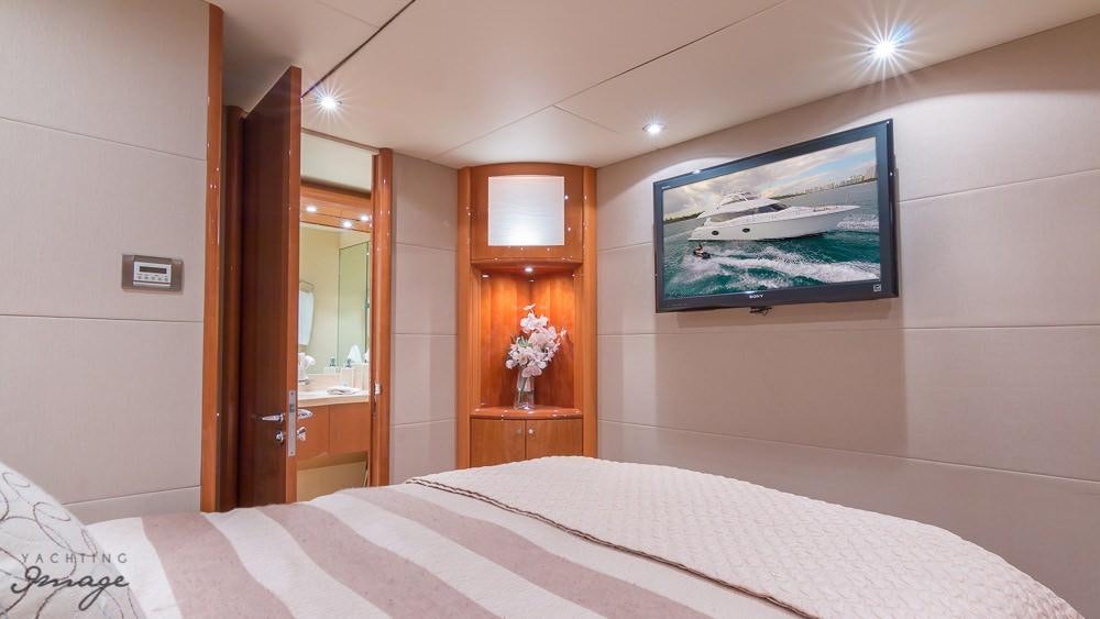 a room with a bed and a window aboard CHIP Yacht for Charter