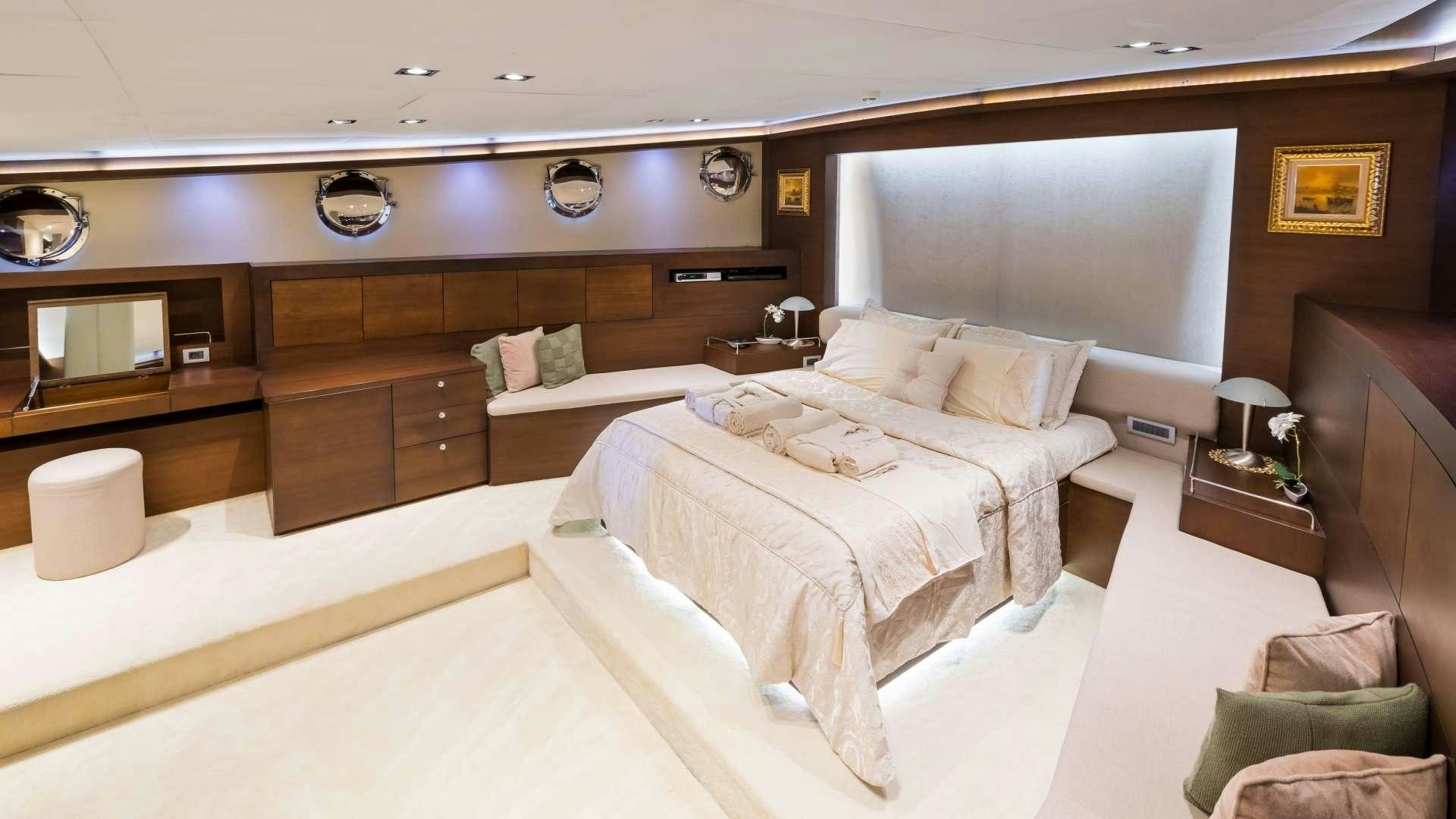 a room with a bed and a couch aboard MEIRA Yacht for Charter
