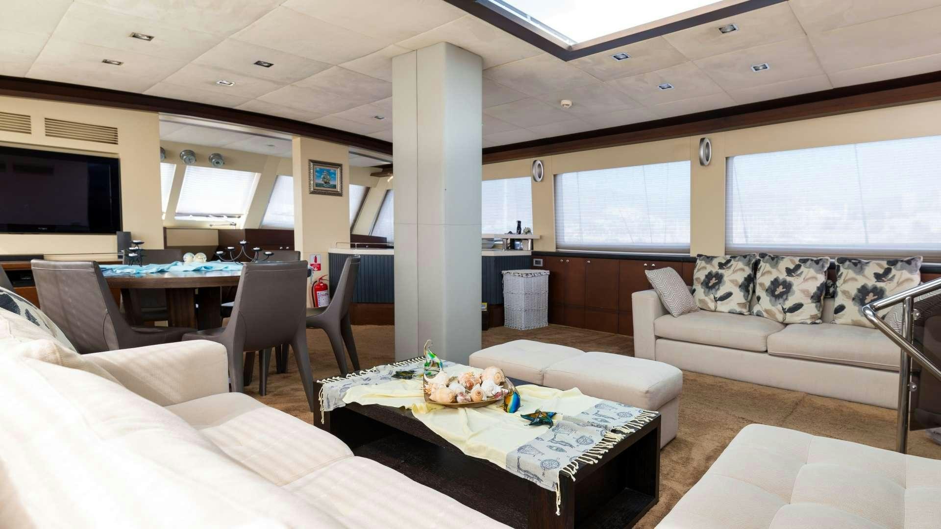 a living room with a couch and a table aboard MEIRA Yacht for Charter