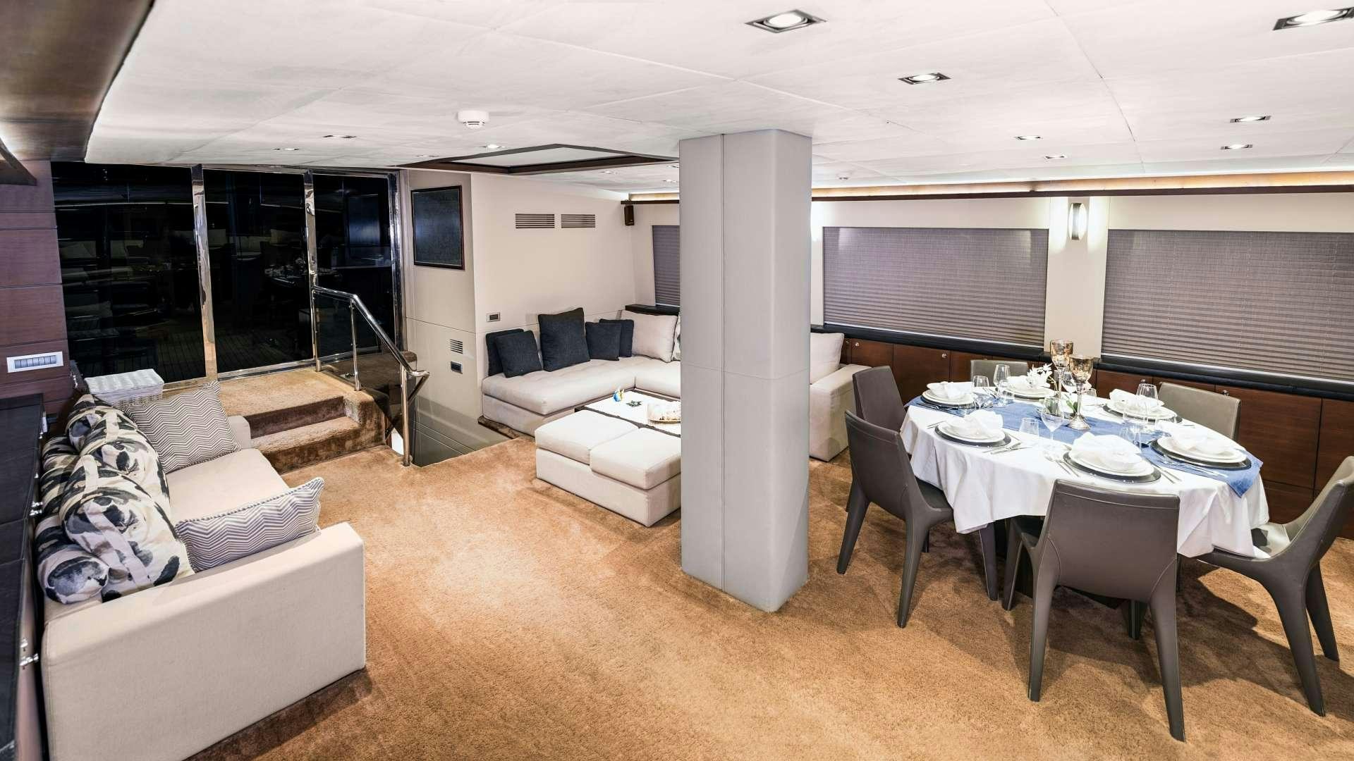 a large room with a table and chairs aboard MEIRA Yacht for Charter