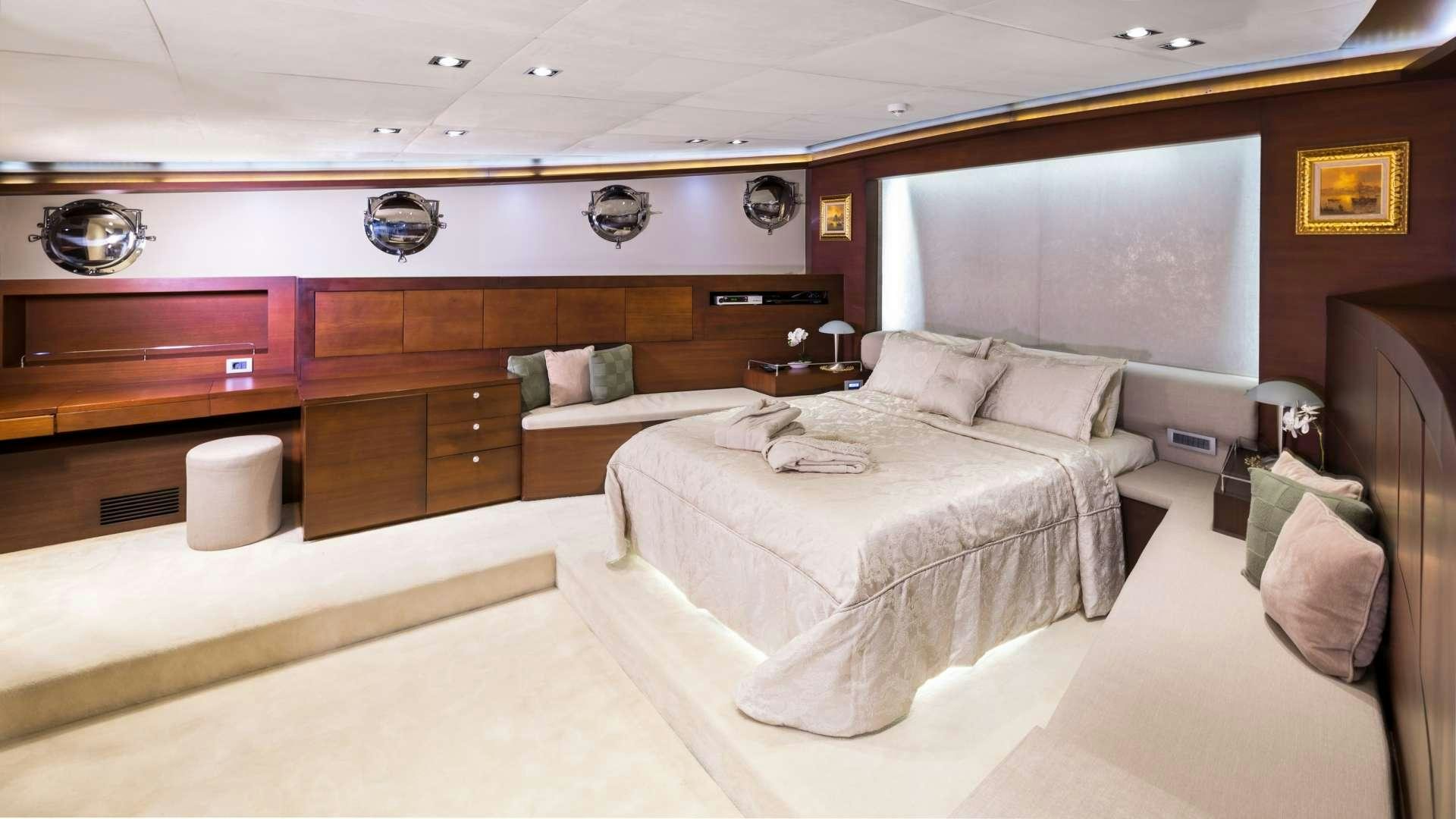 a room with a bed and a desk aboard MEIRA Yacht for Charter