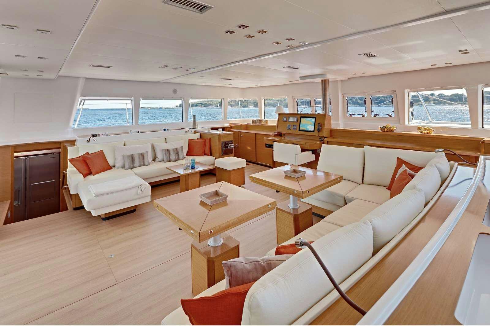 a room with a couch and a table aboard GB ODYSSEY Yacht for Charter