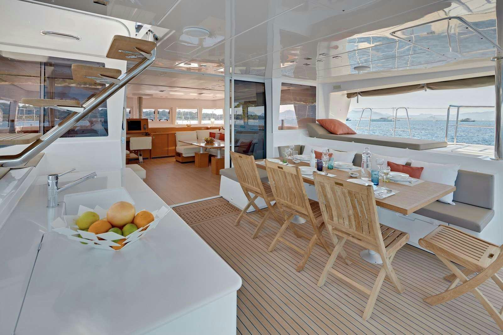a room with tables and chairs aboard GB ODYSSEY Yacht for Charter