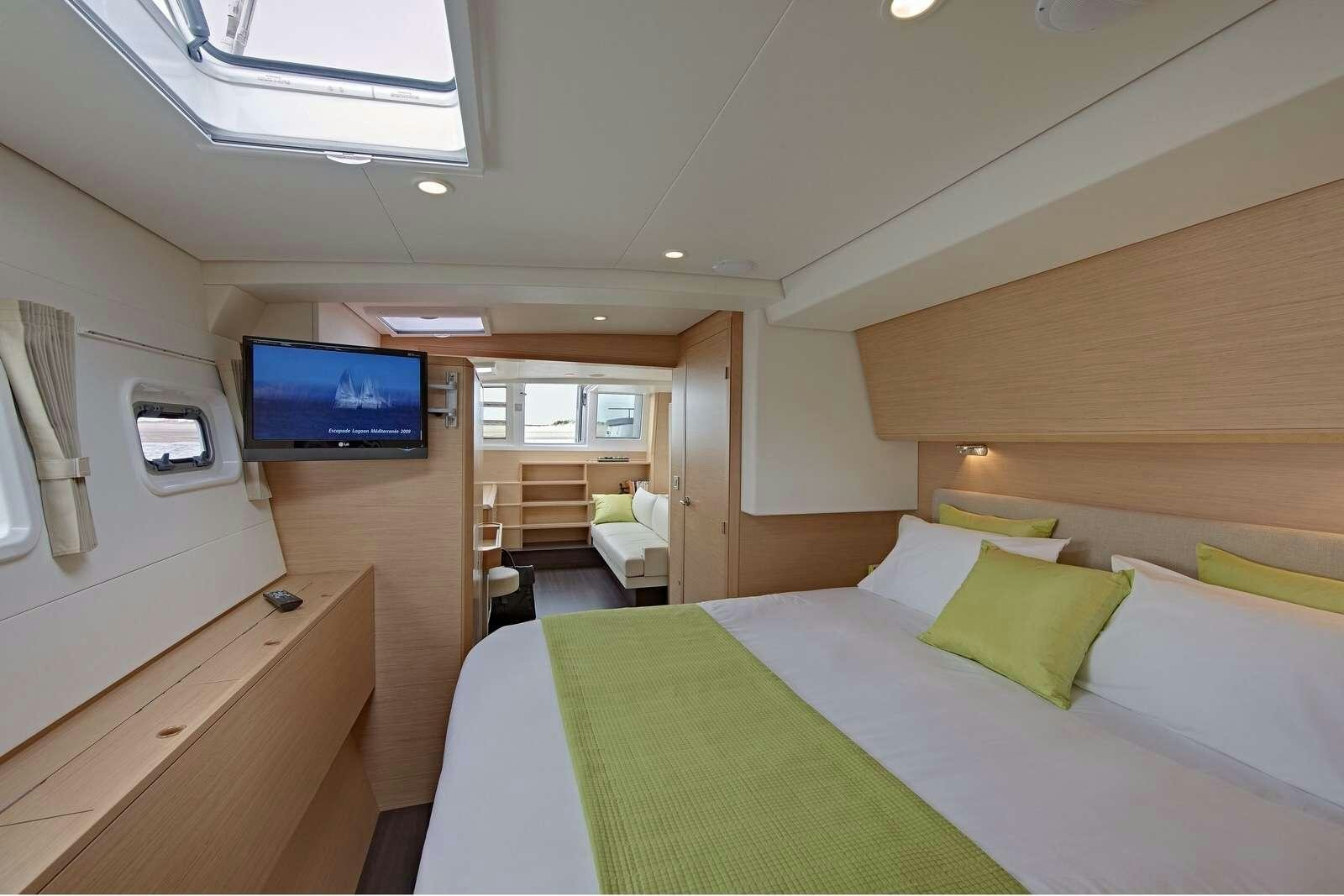a room with a bed and a tv aboard GB ODYSSEY Yacht for Charter