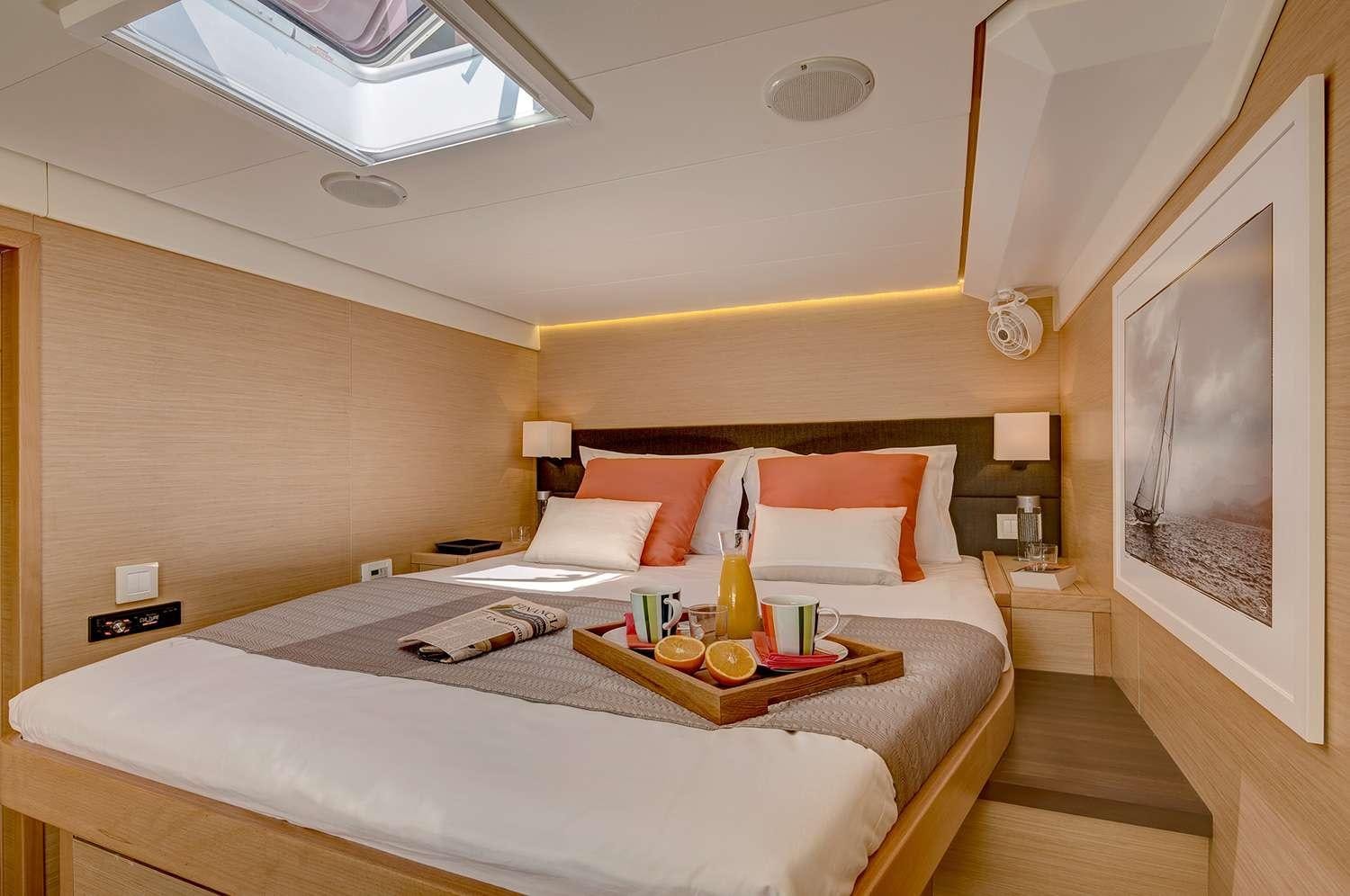 a hotel room with a bed and a table aboard GB ODYSSEY Yacht for Charter