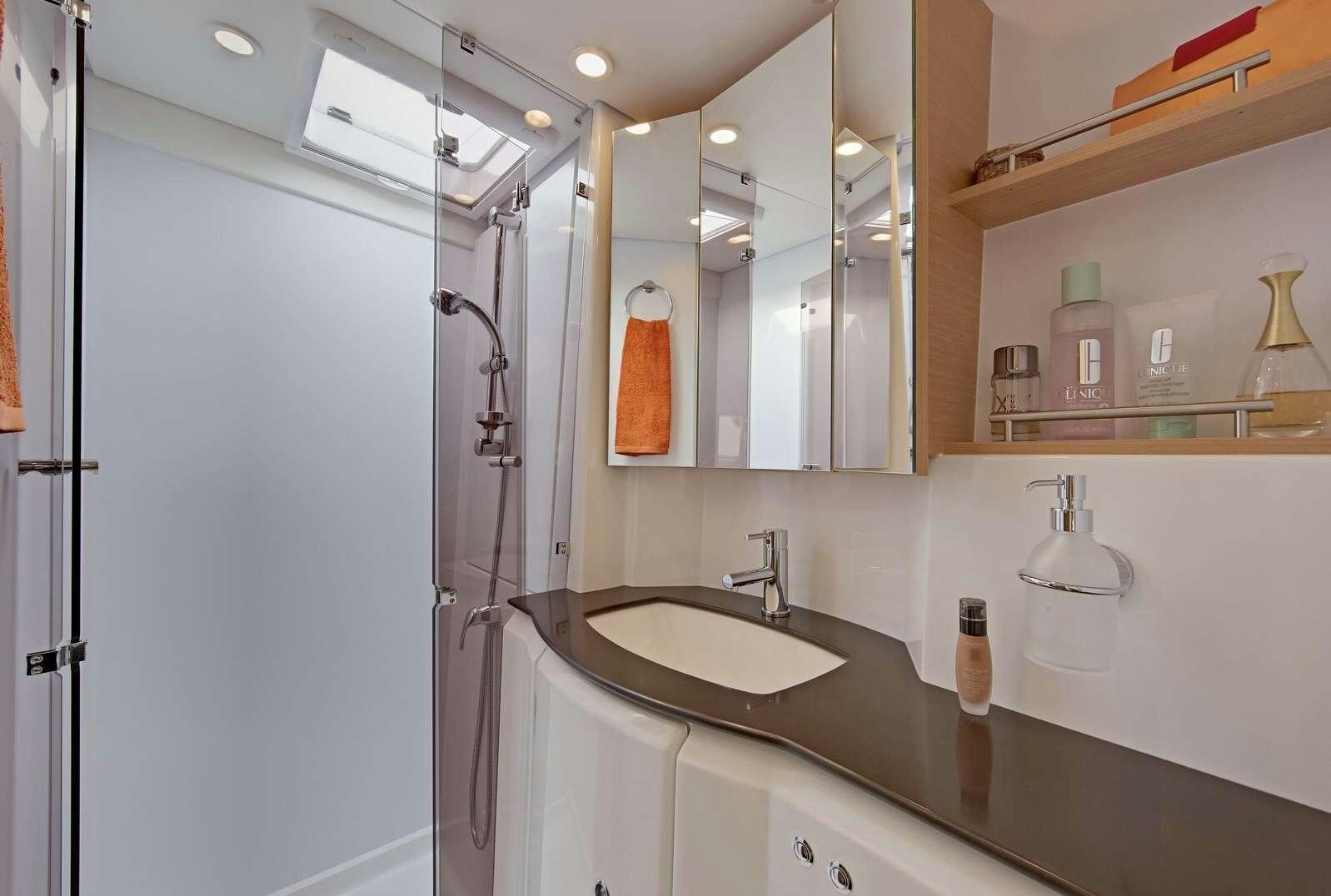 a bathroom with a sink and a shower aboard GB ODYSSEY Yacht for Charter