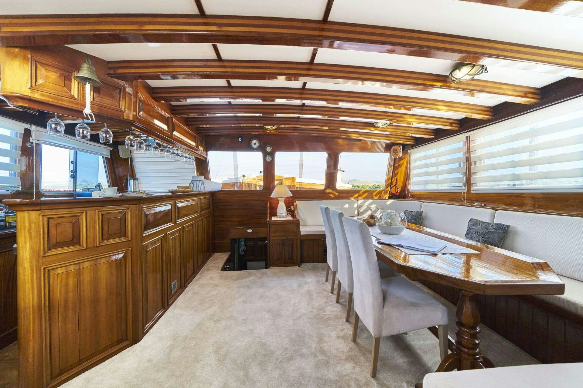 a large kitchen with wooden cabinets aboard PERLA Yacht for Charter