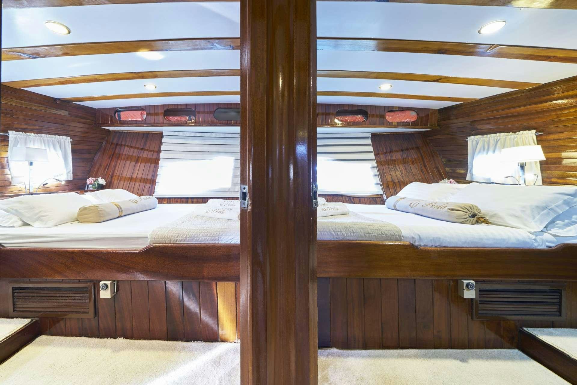 a room with a bed and a window aboard PERLA Yacht for Charter