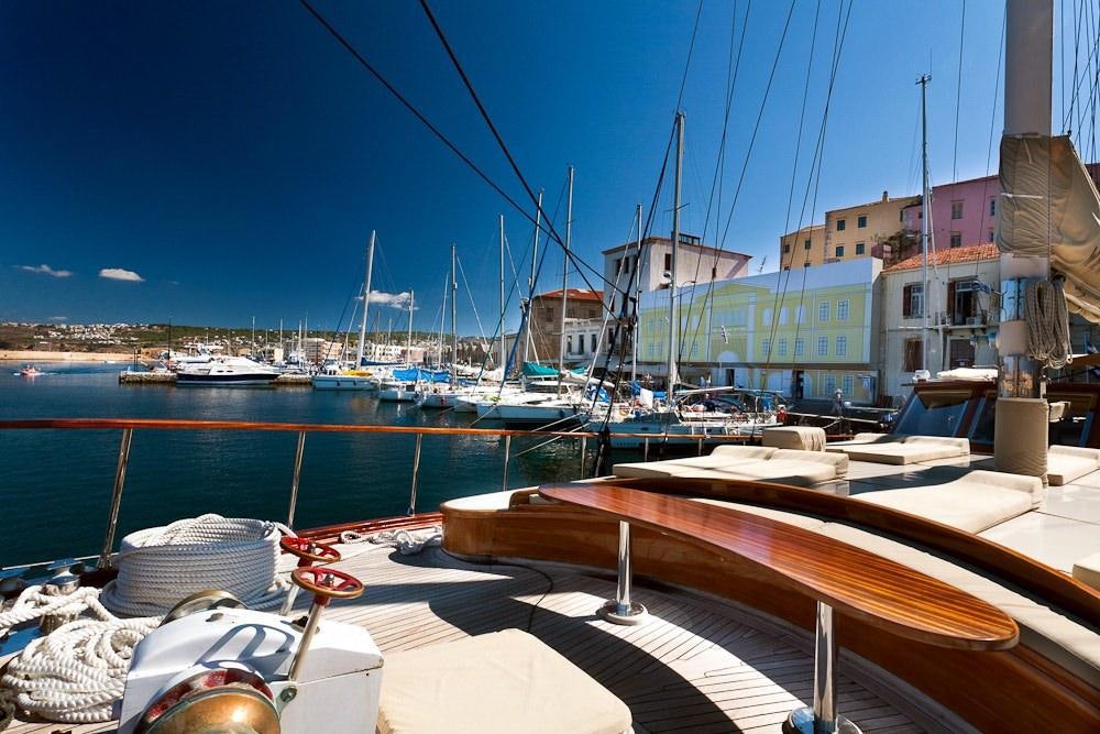 a marina with boats and buildings aboard AEGEAN SCHATZ Yacht for Charter