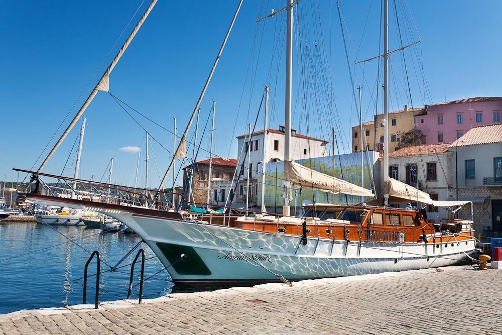 a boat docked at a pier aboard AEGEAN SCHATZ Yacht for Charter