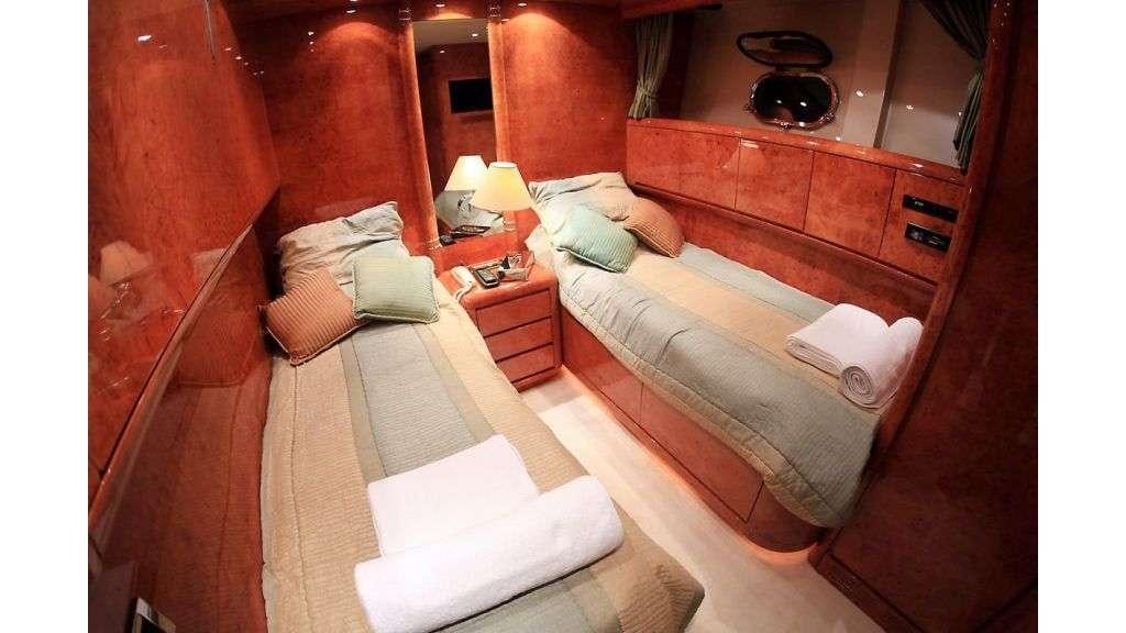a room with a bed and a dresser aboard MINA II Yacht for Charter