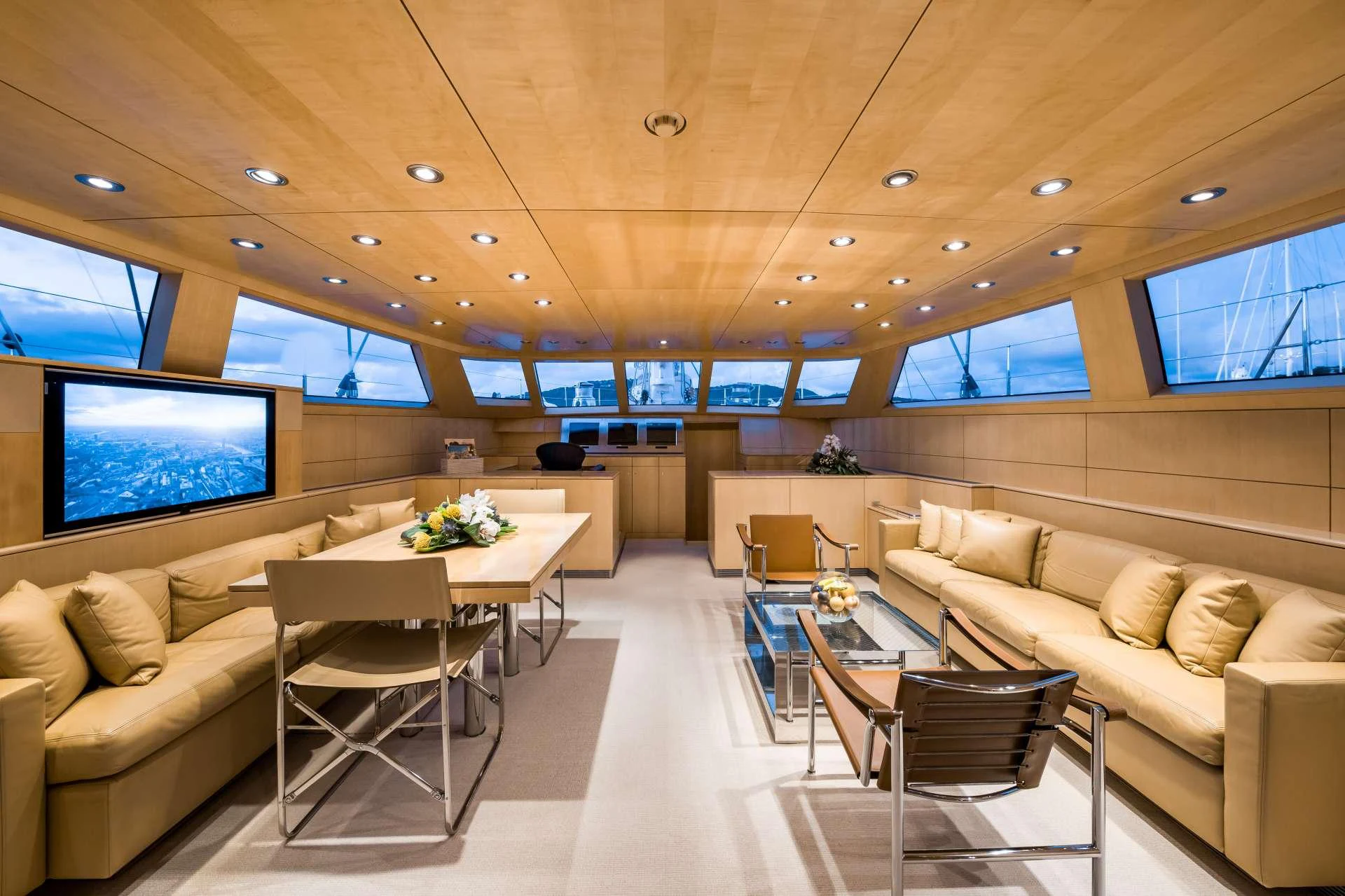 The yacht's salon features luxurious seating, a dining area, and large windows for panoramic views. aboard SPIIP Yacht for Charter