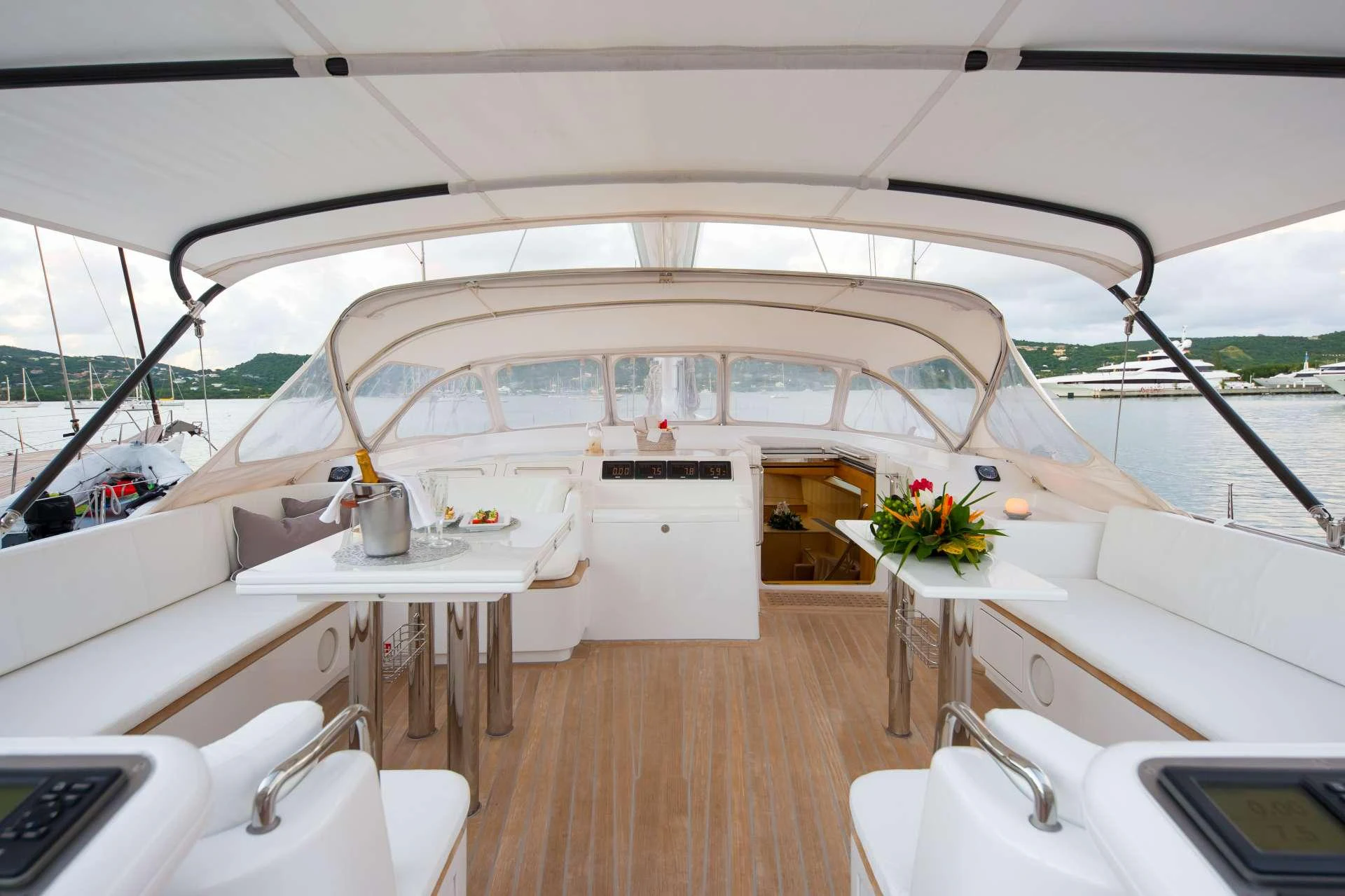The yacht's cockpit features comfortable seating and a well-appointed dining area under a protective canopy. aboard SPIIP Yacht for Charter