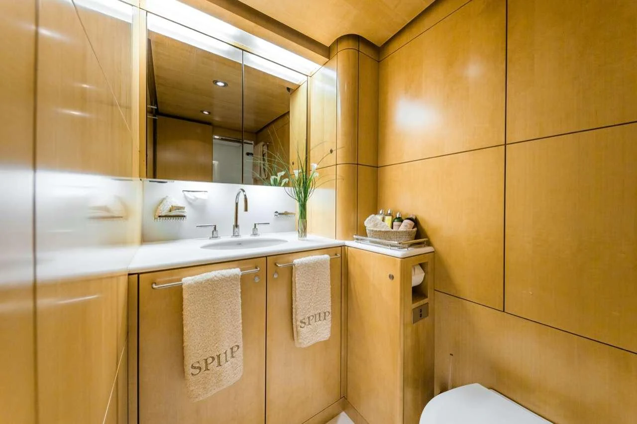 The bathroom features elegant wood paneling and modern fixtures. aboard SPIIP Yacht for Charter