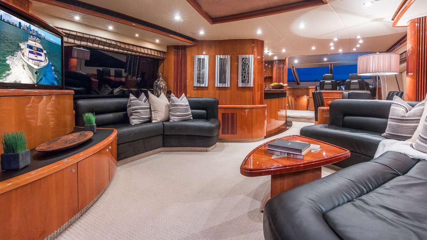 a living room with a couch and a coffee table aboard SS ARTS Yacht for Charter