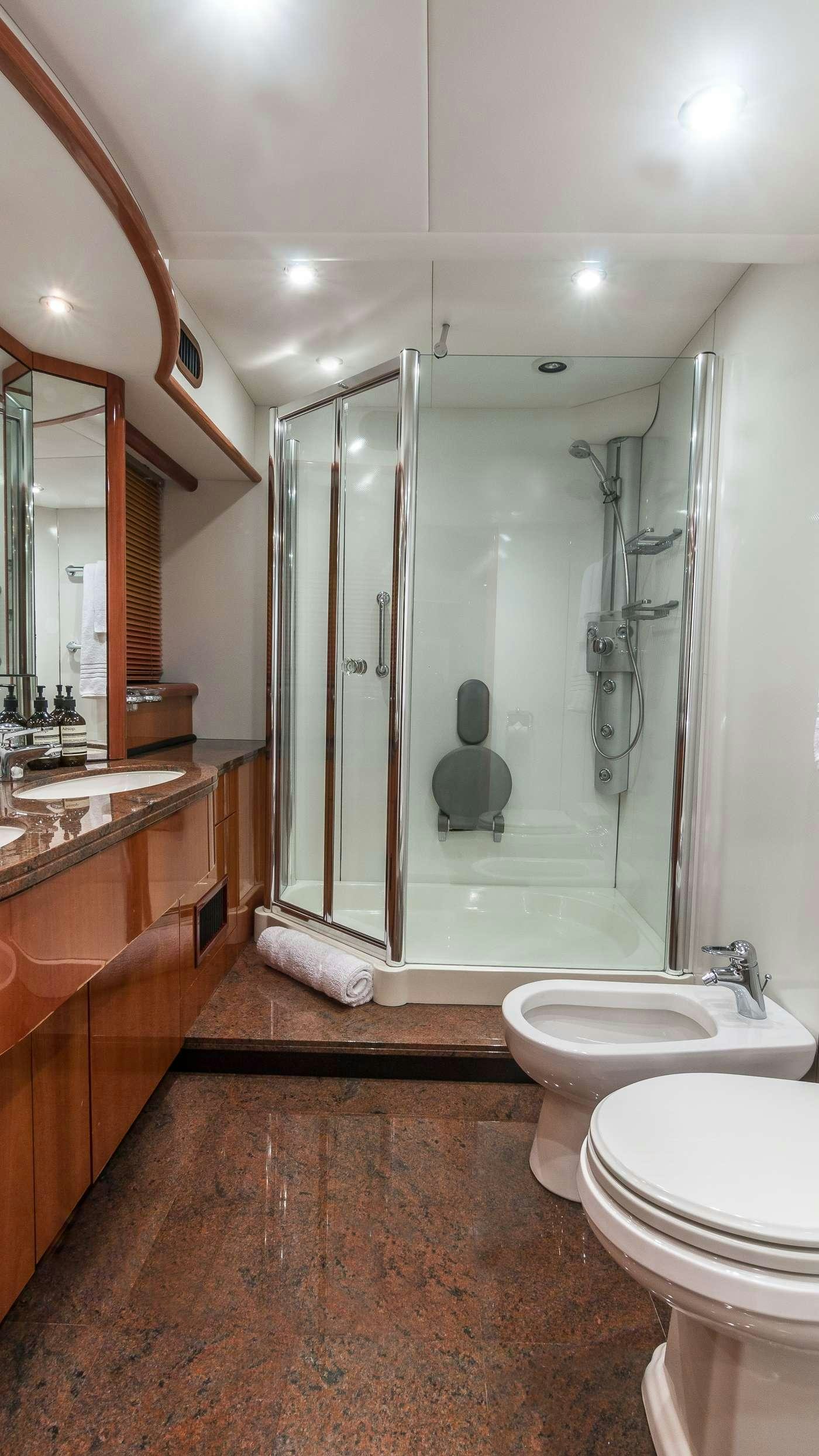 a bathroom with a glass shower aboard SS ARTS Yacht for Charter