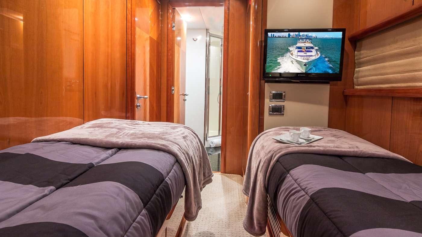 a hotel room with a tv aboard SS ARTS Yacht for Charter