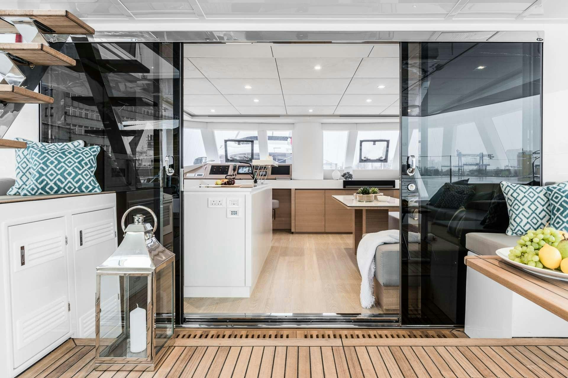 a kitchen with a large window aboard ANNETTE2 Yacht for Charter