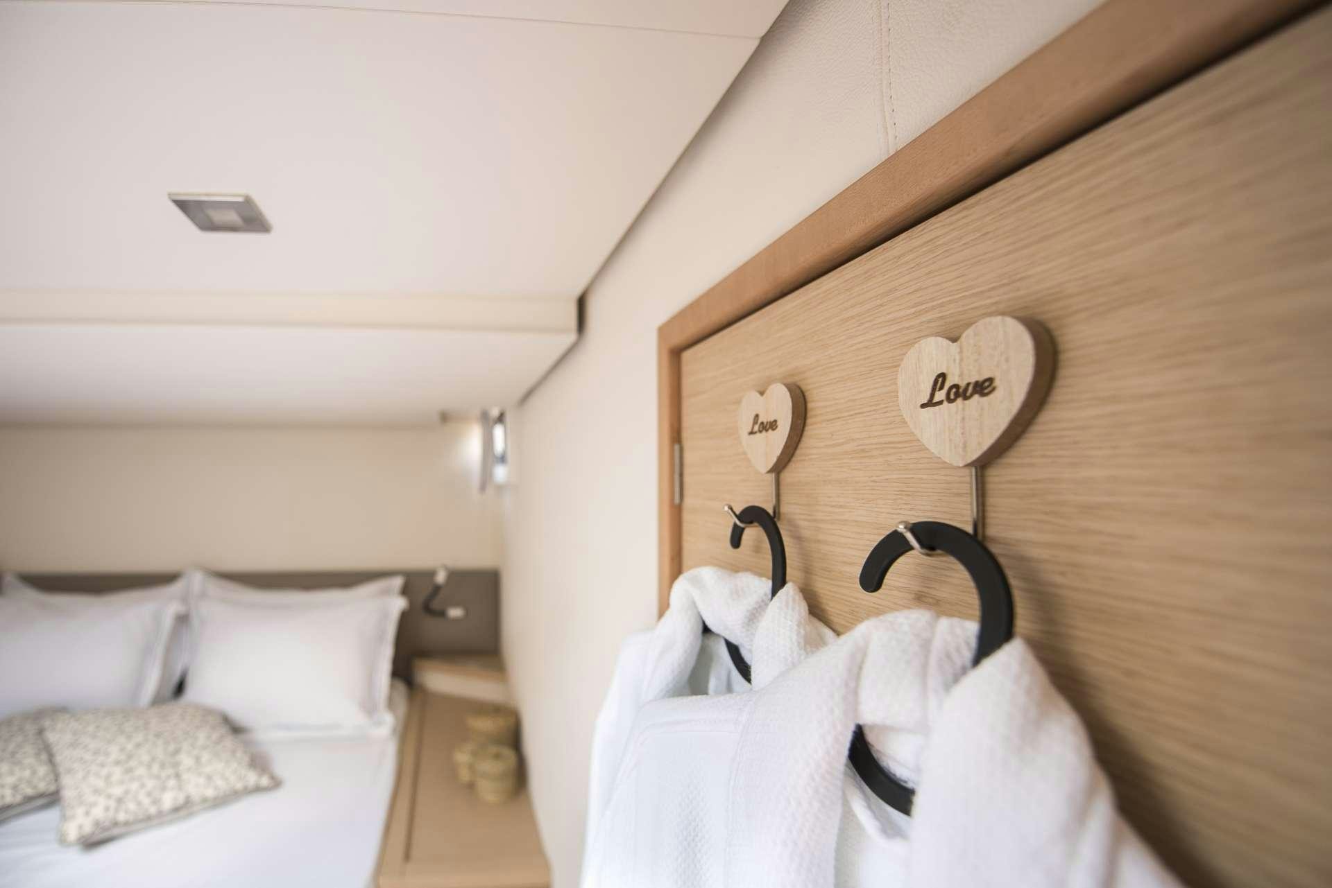 a bed with a wood headboard aboard Sea Energy V Yacht for Charter