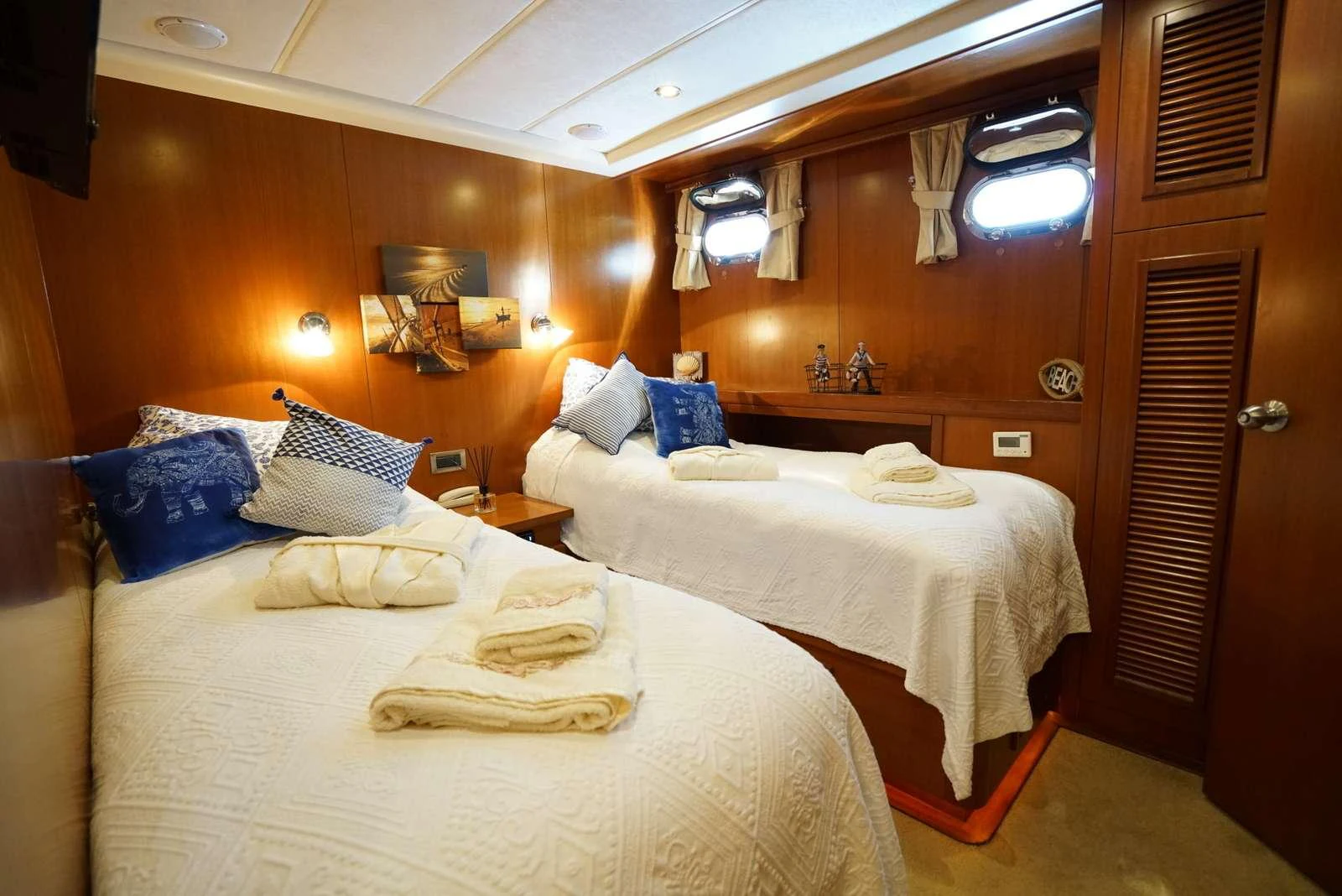 a room with beds and a wood door aboard ARABELLA Yacht for Charter