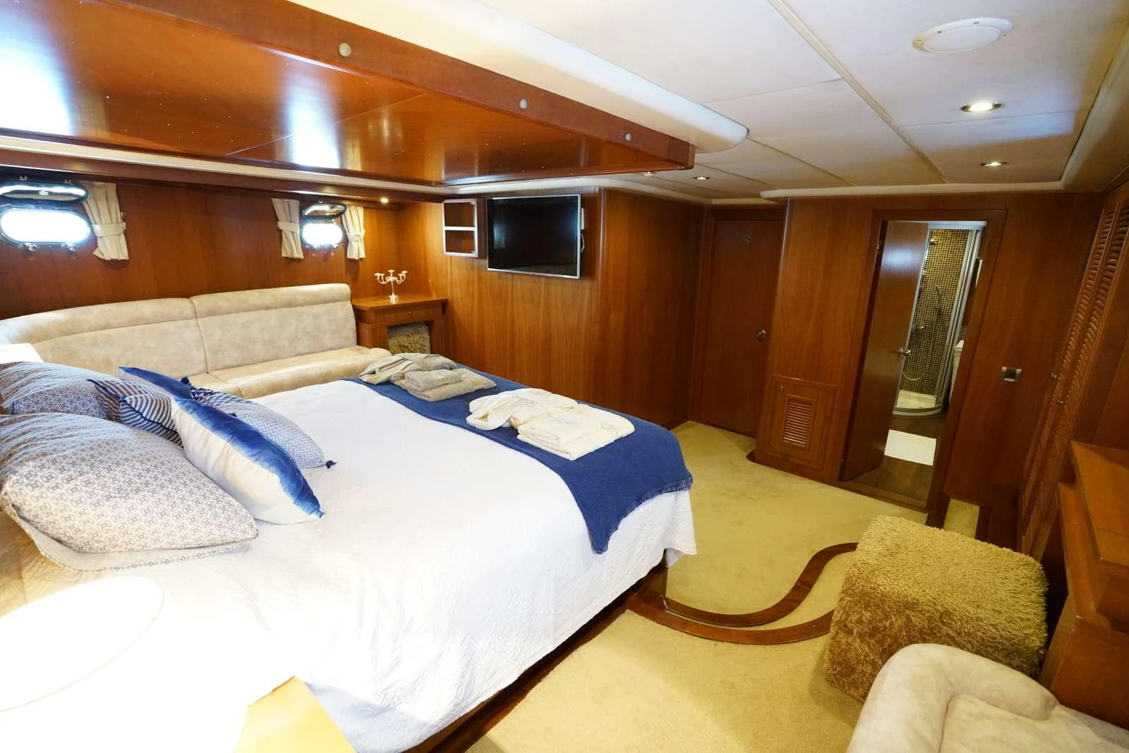 a room with a bed and a television aboard ARABELLA Yacht for Charter