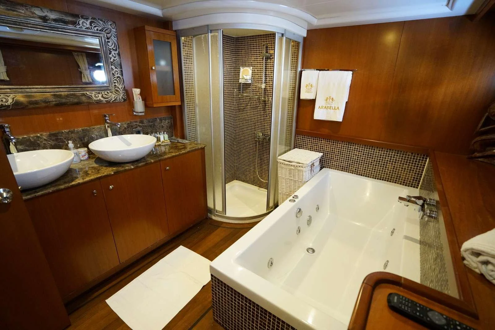 a bathroom with a bathtub sink and a mirror aboard ARABELLA Yacht for Charter