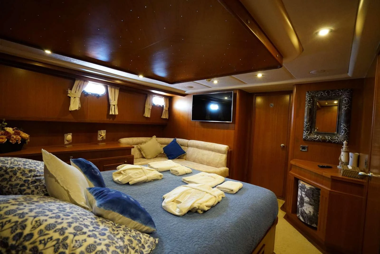a bed with blue sheets aboard ARABELLA Yacht for Charter