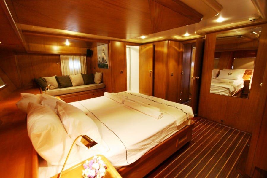 a room with a bed and a mirror aboard MEIN SCHATZ Yacht for Charter
