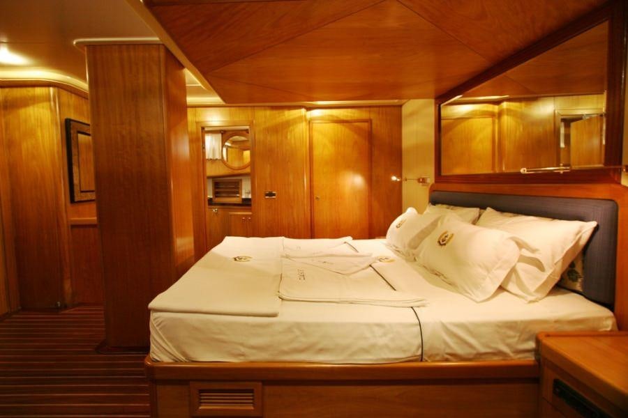 a bed with white sheets aboard MEIN SCHATZ Yacht for Charter
