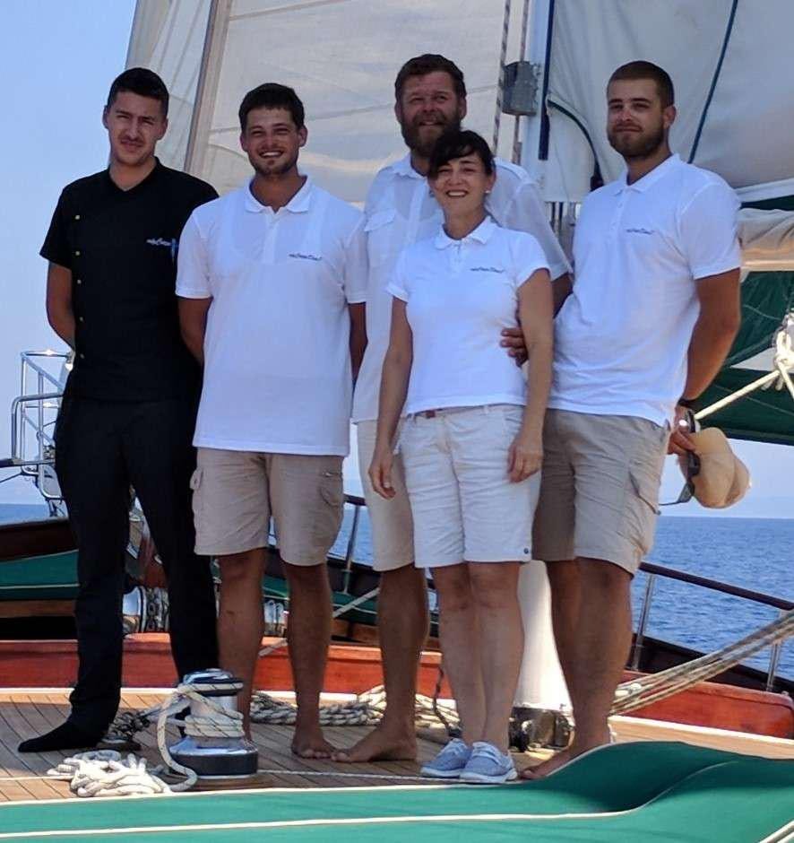 a group of men posing for a photo aboard Carpe Diem 7 Yacht for Charter