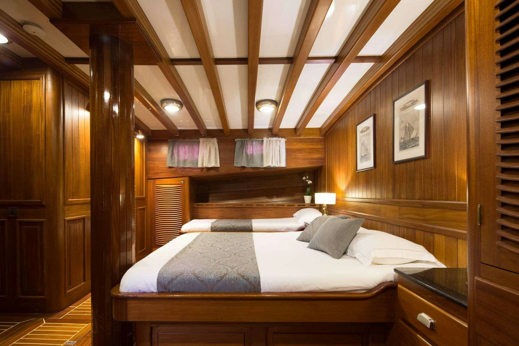 a bed with a wooden canopy aboard Carpe Diem 7 Yacht for Charter