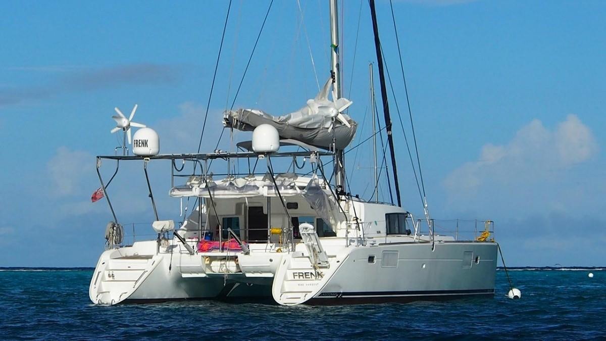 a large white boat in the water aboard FRENK Yacht for Charter