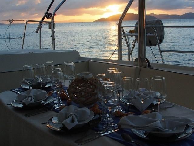 a table set with glasses and food aboard FRENK Yacht for Charter
