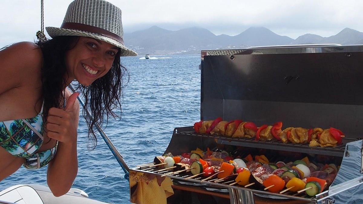 a woman in a boat with a tray of food aboard FRENK Yacht for Charter