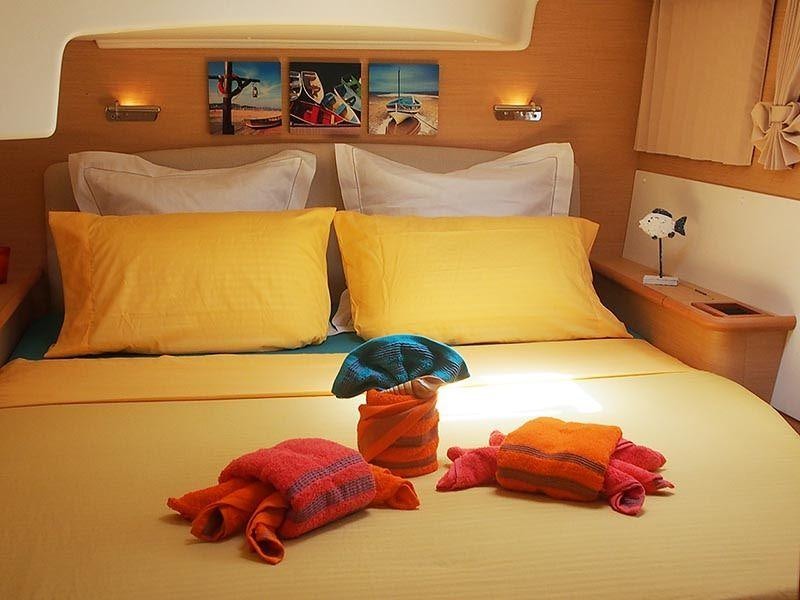 a bed with pillows and pillows aboard FRENK Yacht for Charter