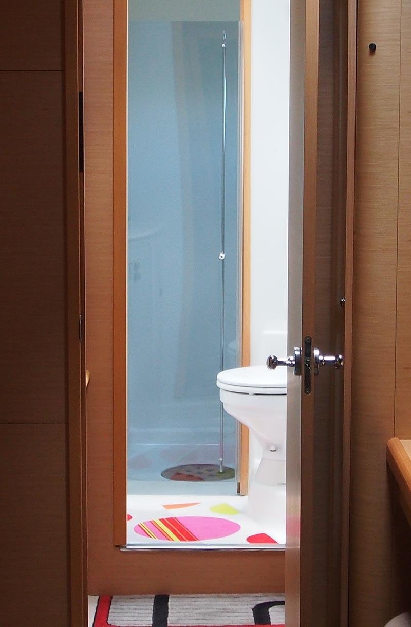 a bathroom with a blue door aboard FRENK Yacht for Charter