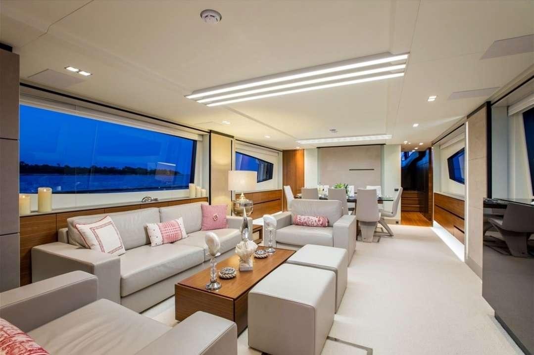 a living room with a large screen aboard KEROS ISLAND Yacht for Charter