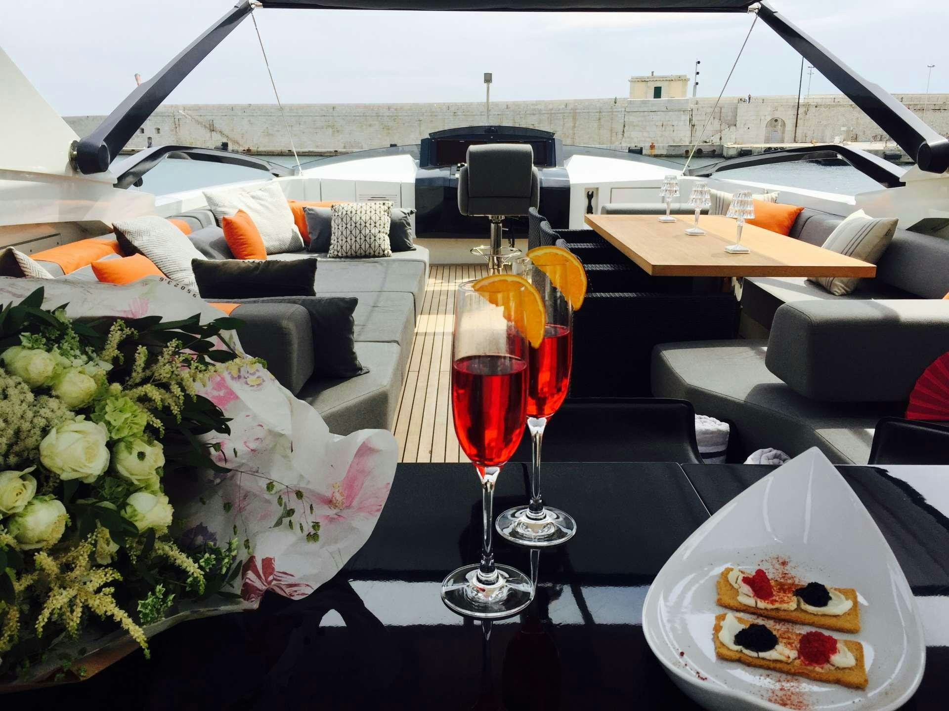 a table with food and wine aboard KEROS ISLAND Yacht for Charter