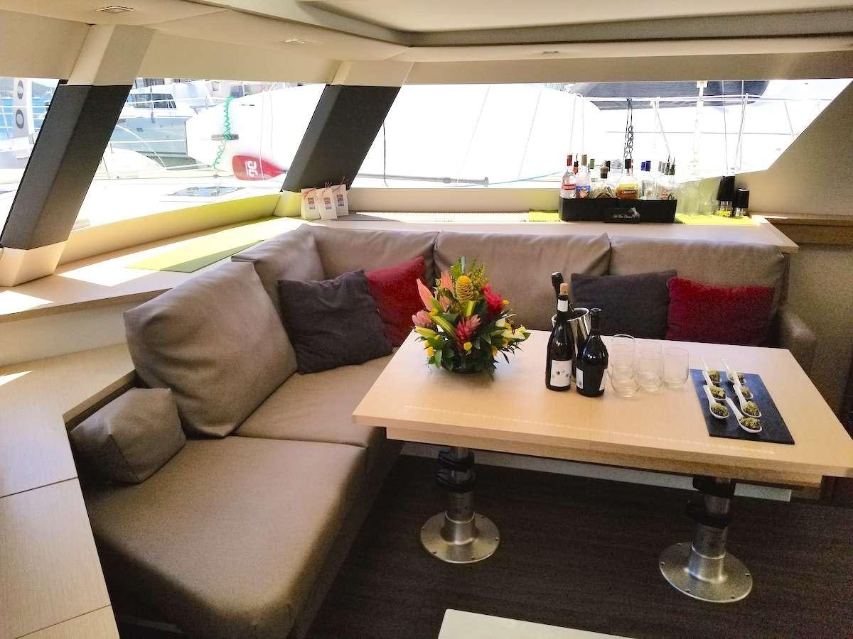 a couch and a table in a room aboard MARIANN Yacht for Charter
