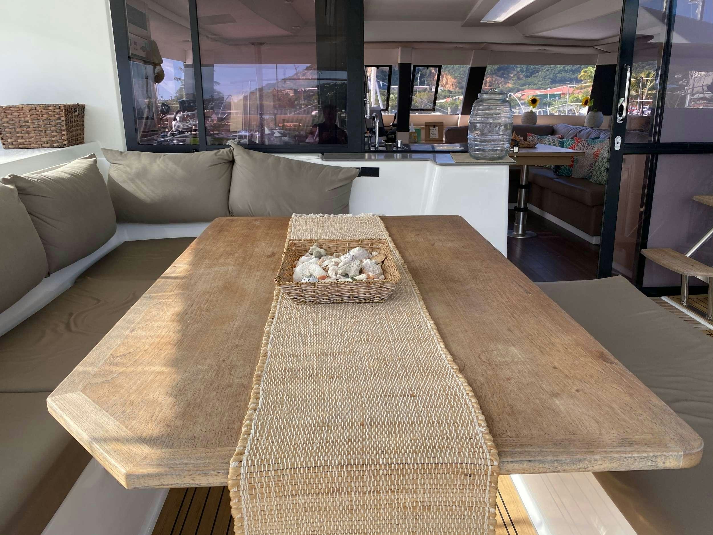 a table with a plate of food on it aboard MARIANN Yacht for Charter