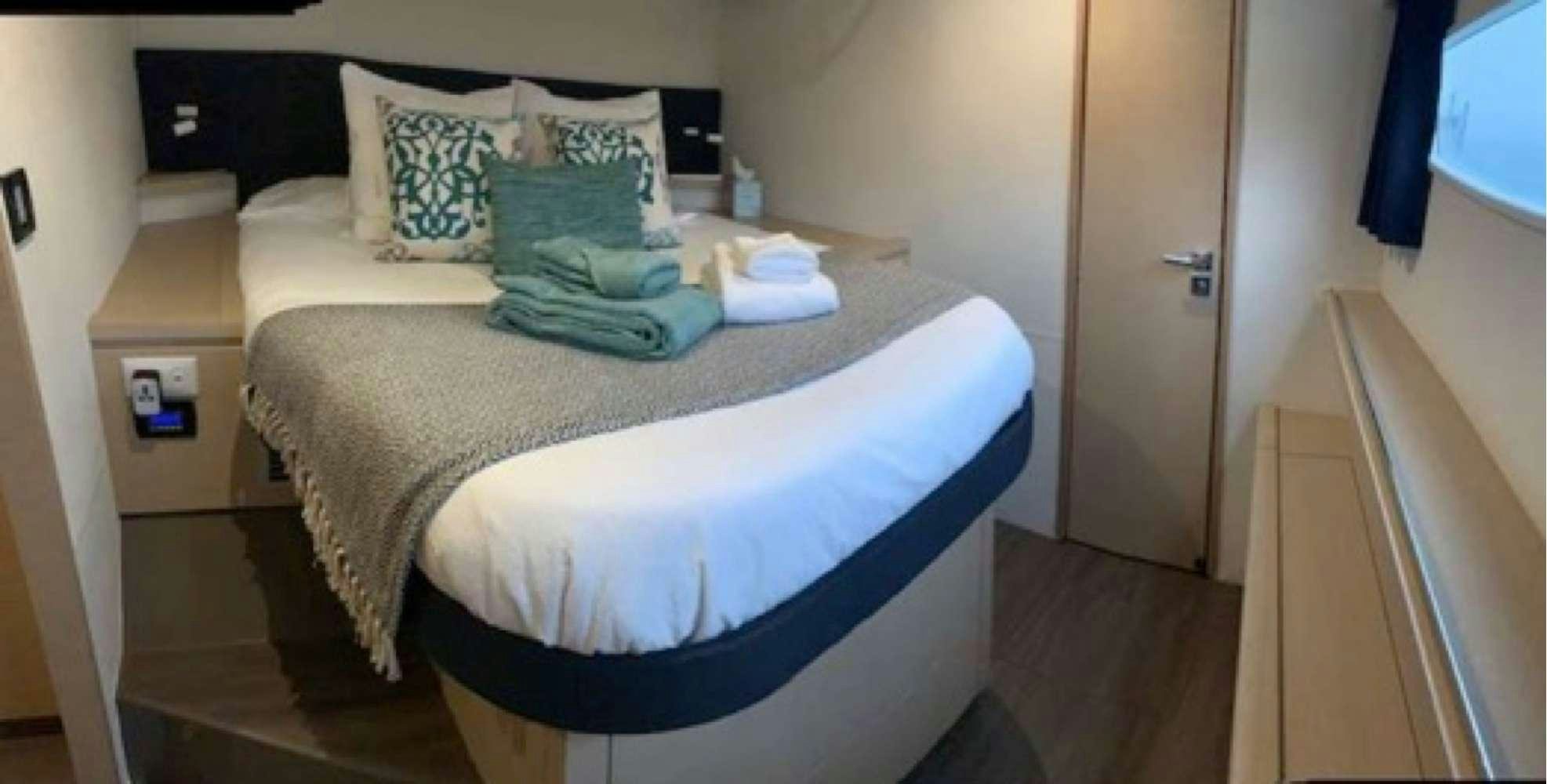 a bed with pillows aboard MARIANN Yacht for Charter