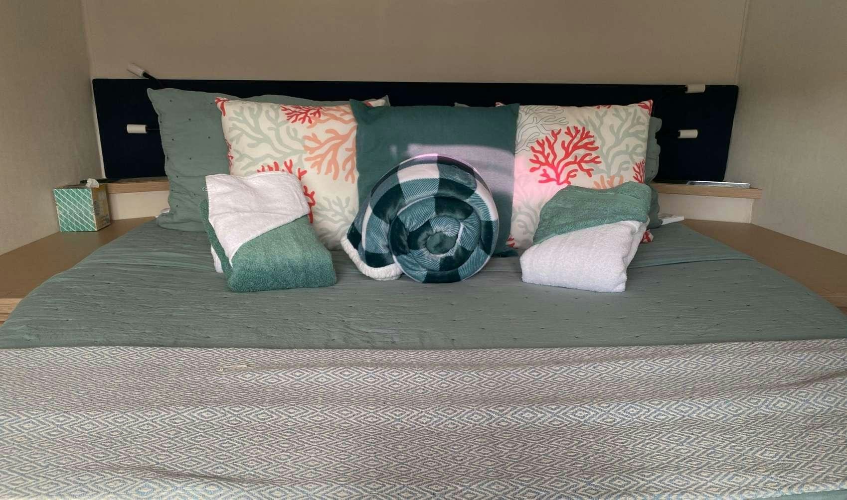 a bed with pillows aboard MARIANN Yacht for Charter