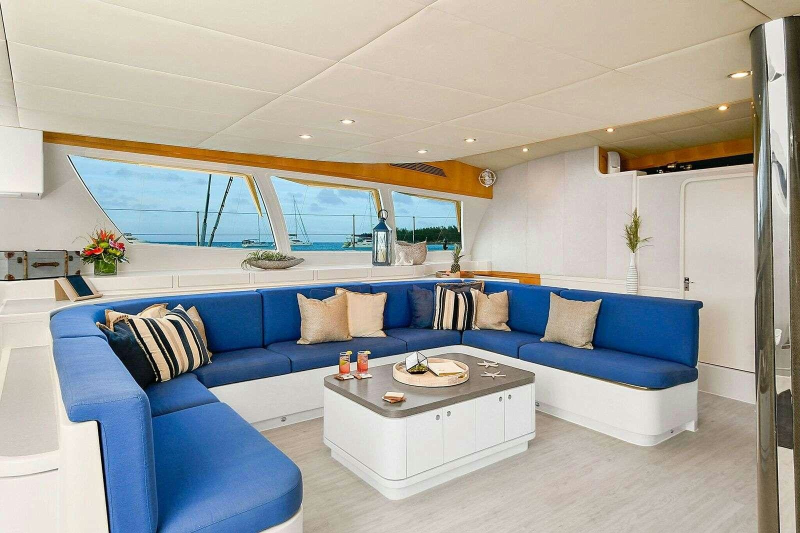 a living room with a blue couch aboard BLUE GRYPHON Yacht for Charter
