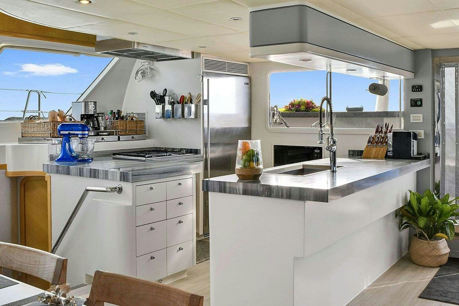 a kitchen with white cabinets aboard BLUE GRYPHON Yacht for Charter