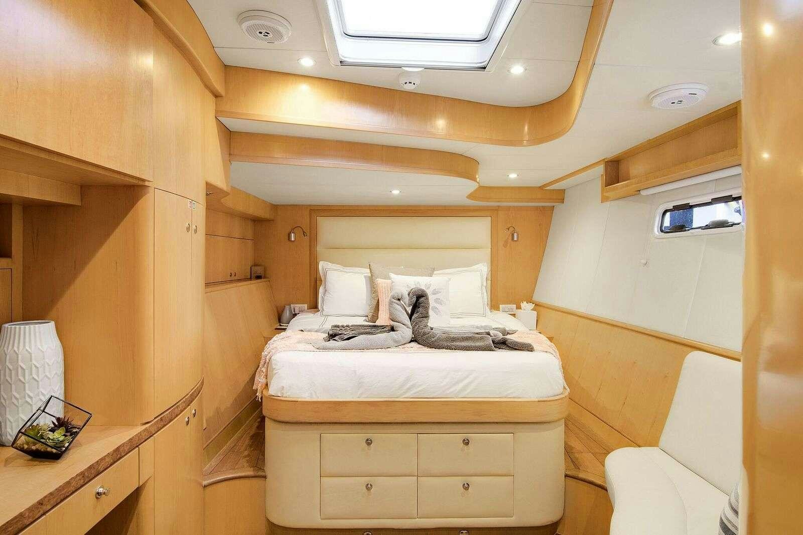 a room with a bed and a window aboard BLUE GRYPHON Yacht for Charter