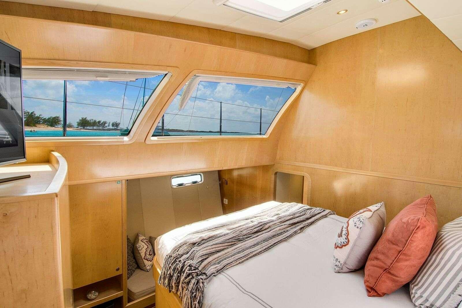 a room with a bed and a tv aboard BLUE GRYPHON Yacht for Charter