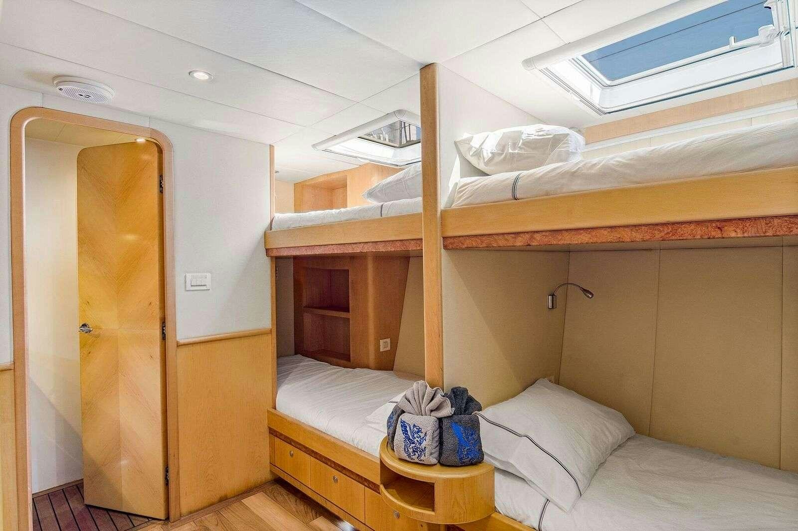 a room with a bed and a closet aboard BLUE GRYPHON Yacht for Charter
