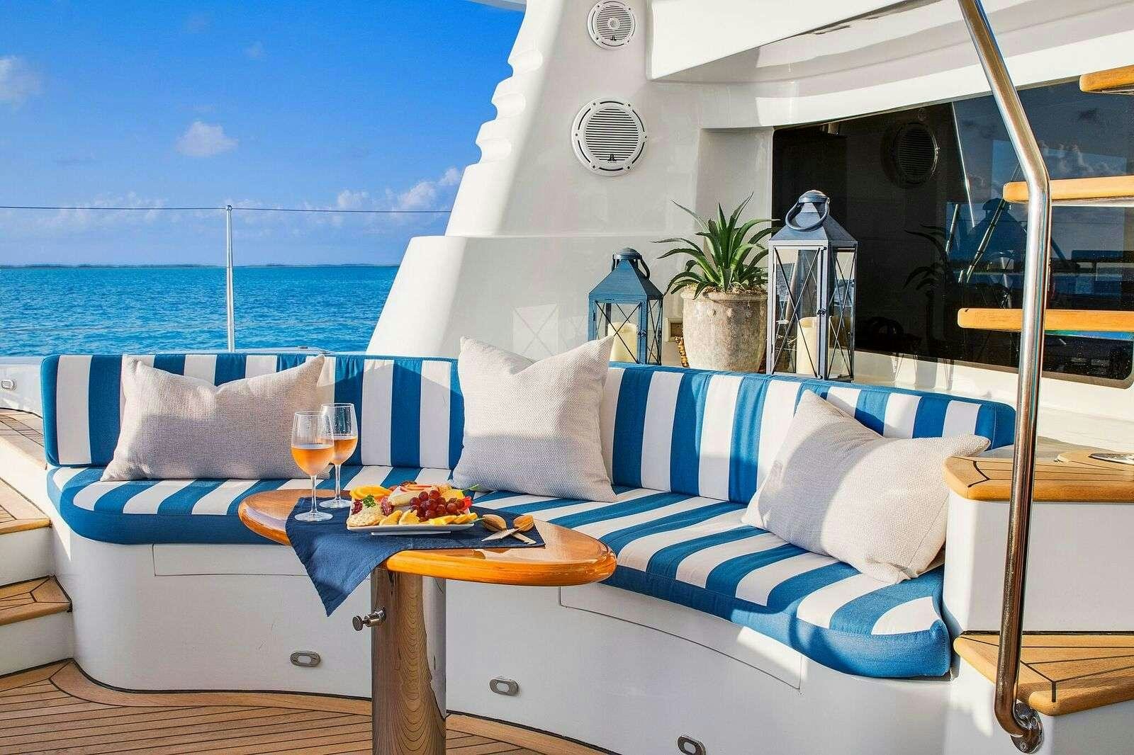 a room with a bed and a table with food on it aboard BLUE GRYPHON Yacht for Charter
